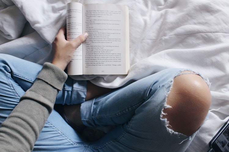 a man holding a book - speed reading